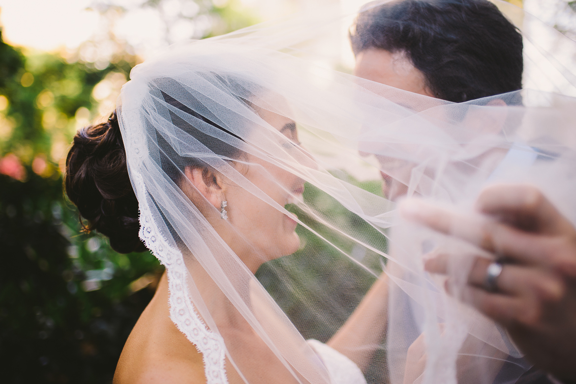 Wedding travel photography bride taking off veil