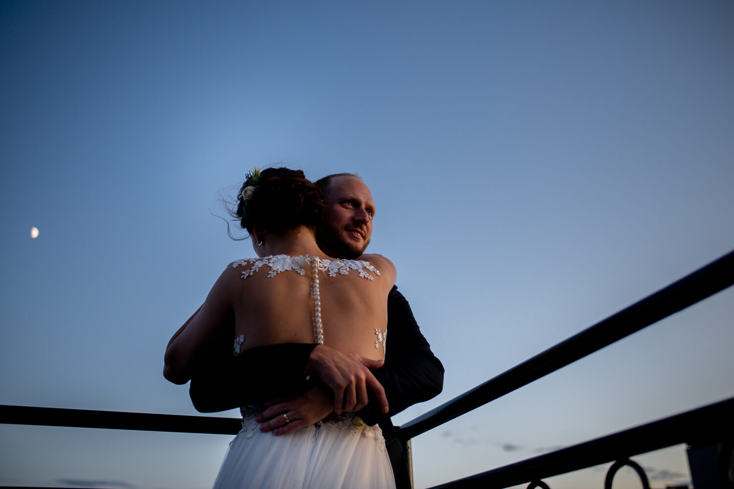 Wedding travel photography at night bride and groom hugging